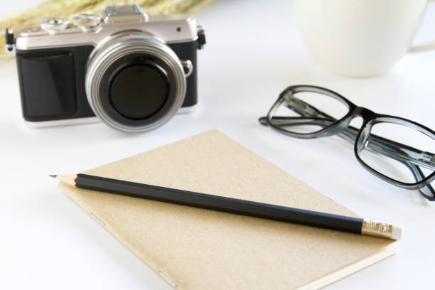 istock Notebook ,pencil ,camera and glasses on white background. 840512534