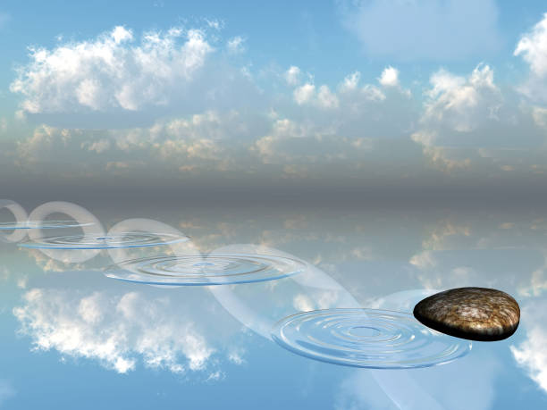 Bright daylight illuminates smooth stones in coastal Sweden, reflecting fluffy clouds in the still water, creating a peaceful and serene atmosphere ideal for contemplation and relaxation.
