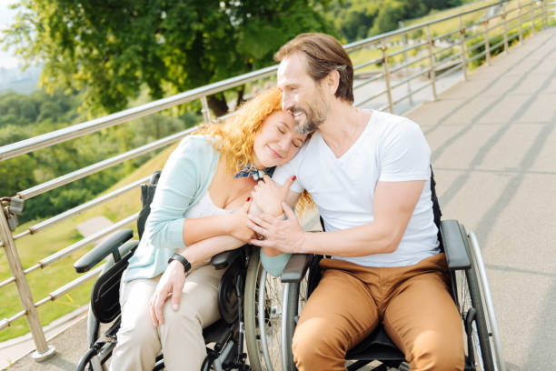 istock Pleasant senior wheelchaired couple bionding to each other 840513160