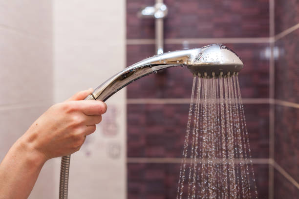 istock Water streams flow out of working shower head right down 840513252