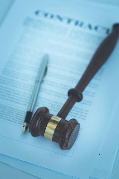 istock WOODEN JUDGE GAVEL WITH CONTRACT DOCUMENT AND PEN CONCEPT 840518710