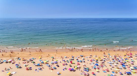Aerial. Photos of the beach and tourists of the city of Albufeira. From the sky.