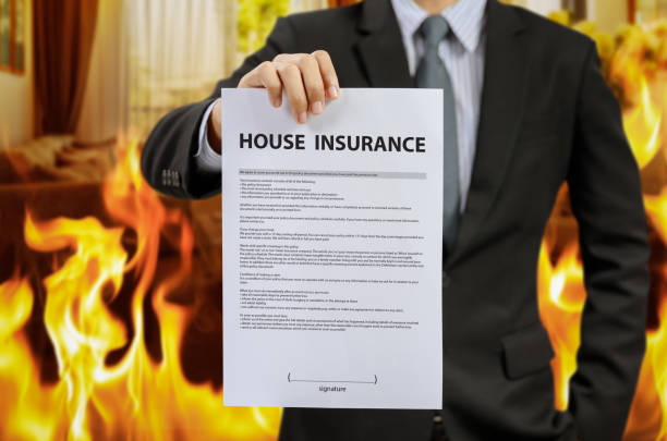 istock businessman show home insurance policy with fire 840519212