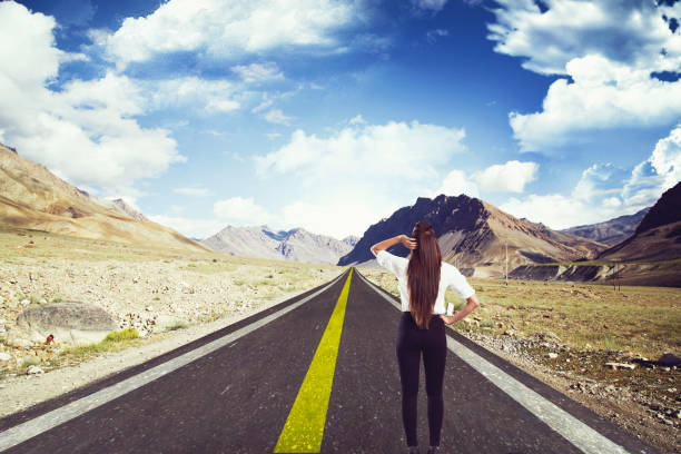 Confused businesswoman standing on road to success