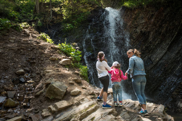 istock Family relaxing near waterfall 840519794