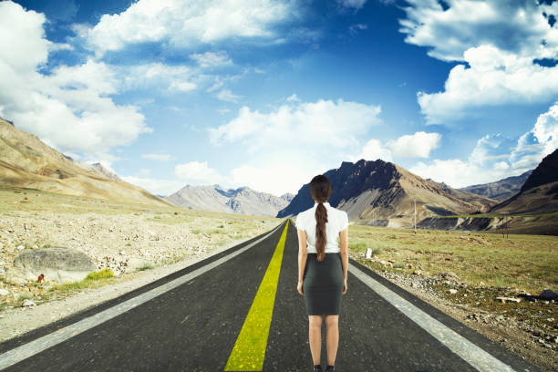Businesswoman standing on road to success