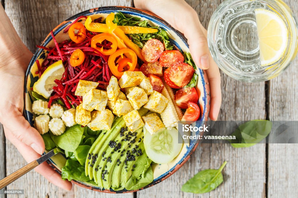 Bright vegetable buddha bowl with tofu. Bright vegetable buddha bowl with tofu. Love for a healthy vegan food concept. Bowl Stock Photo