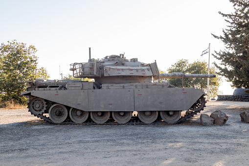 Real armored war tank with camouflage in desert