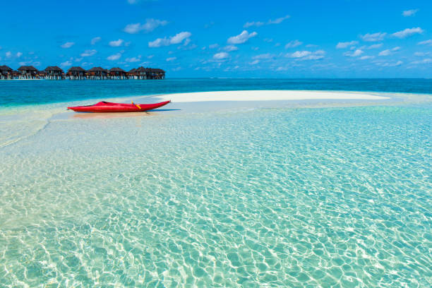 istock beach with water bungalows at Maldives 840535434