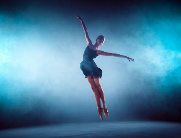 istock Beautiful young ballet dancer jumping on a lilac background 840536026