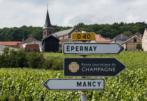 Epernay: Sign of the Route Touristique du Champagne with in the background vineyards of the Champagne district Vallee de Marne, France.