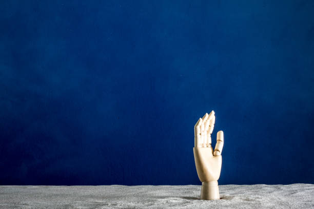 istock A wooden hand gesticulates against a blue background 840536602