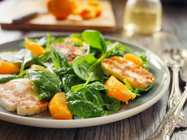 istock Healthy spinach and orange salad with grilled halloumi cheese 840539216