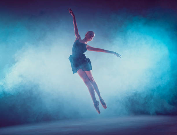 istock Beautiful young ballet dancer jumping on a lilac background 840543242