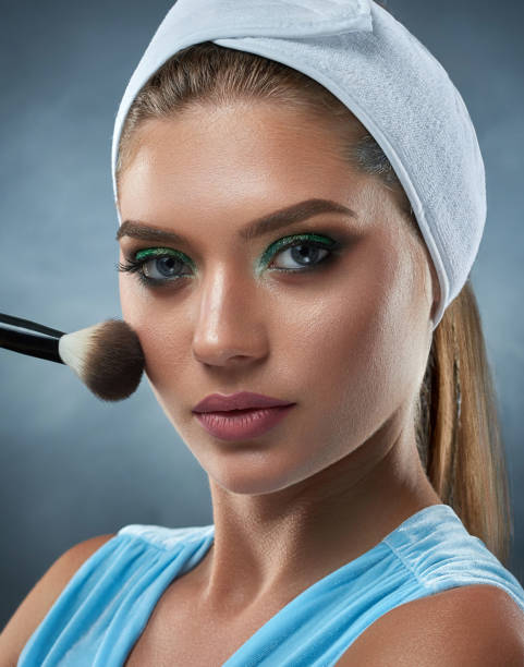 istock Woman in bandage on head drawing blush for herself by ankle. 840543498