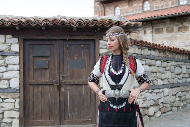 istock Woman in authentic folklore clothes in old Nessebar. Soft focus. 840543998