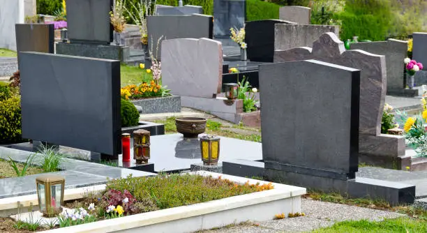 graves with grave stones at a cemetery in spring