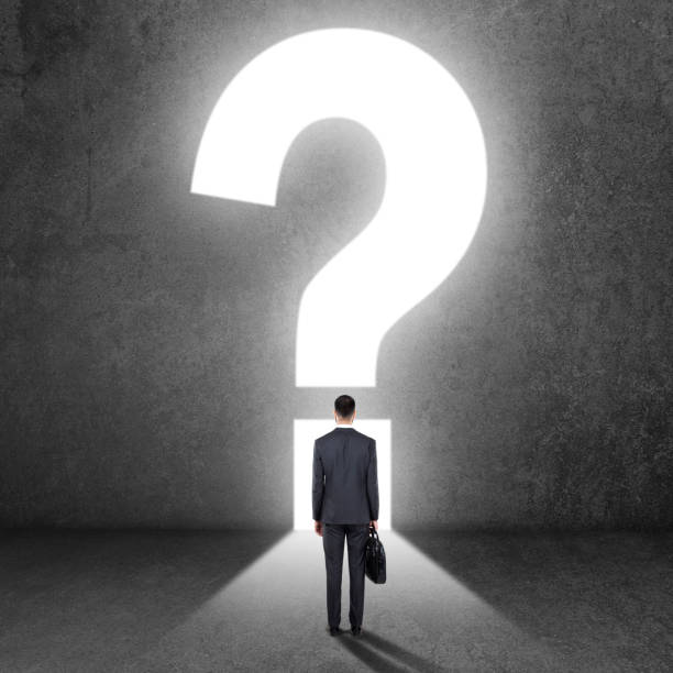 istock Businessman with question mark on wall 840552356