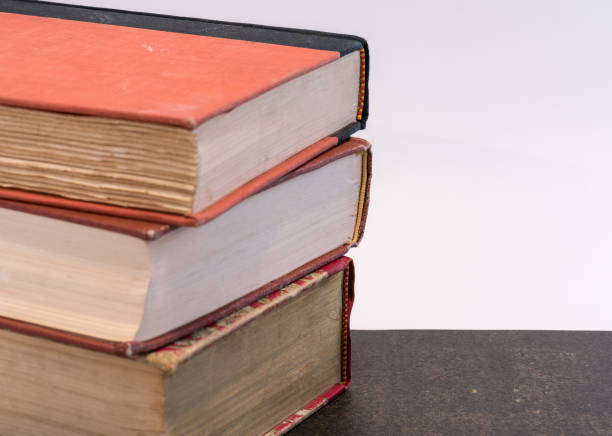 stack of three hardbound books - hardbound imagens e fotografias de stock