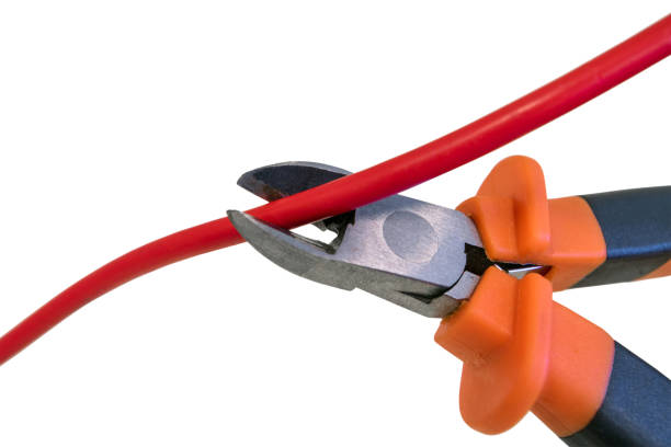 Cutting red wire by nippers, cropping the cable under voltage