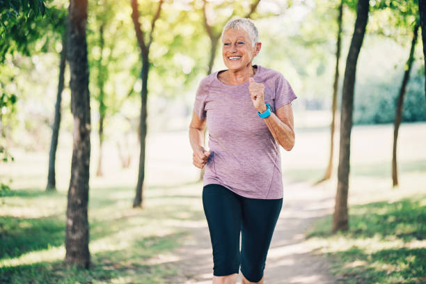 istock Senior woman jogging in a forest 840556186