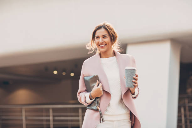 Happy businesswoman with coffee cup stock photo