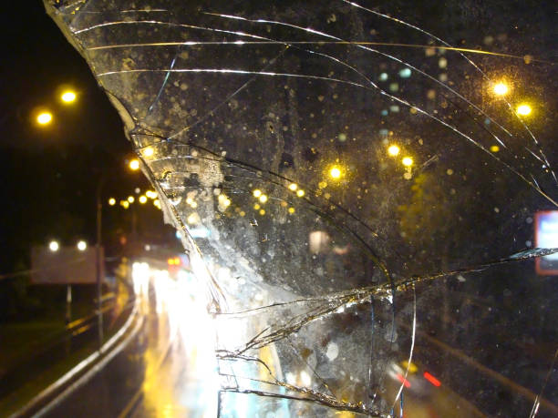 istock Night road in the rain seen through broken window glass 840559228