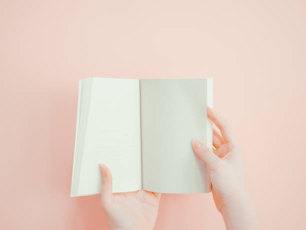 istock asian woman hold , open and present her book or document display by both hand with pink pastel background 840562418