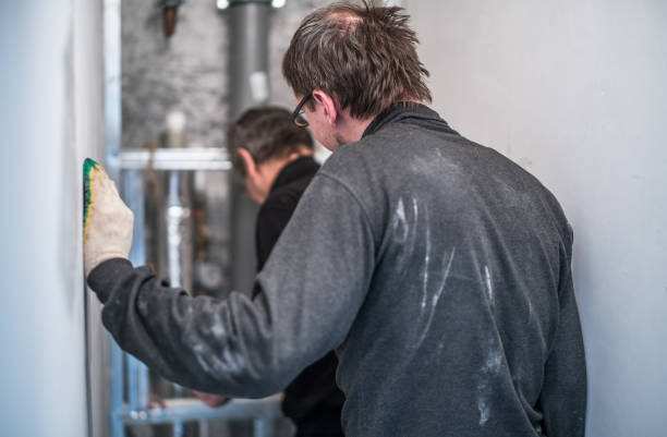 istock 70-years-old active senior man teaching the 30-years-old one. Construction workers - plumbers, working together for home renovation 840571836