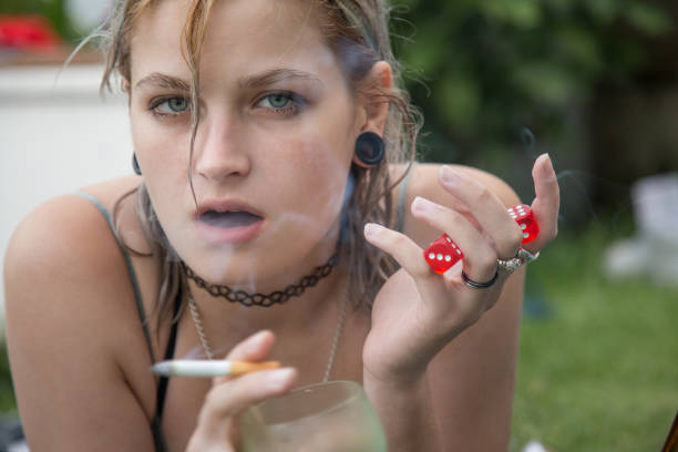 istock Woman with beer and cigarette relaxing 840572782