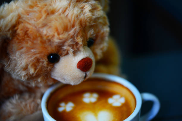 istock Teddy bear and coffee cup on table in the cafe 840581764