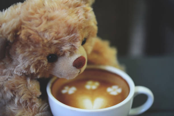 istock Teddy bear and coffee cup on table in the cafe 840581866