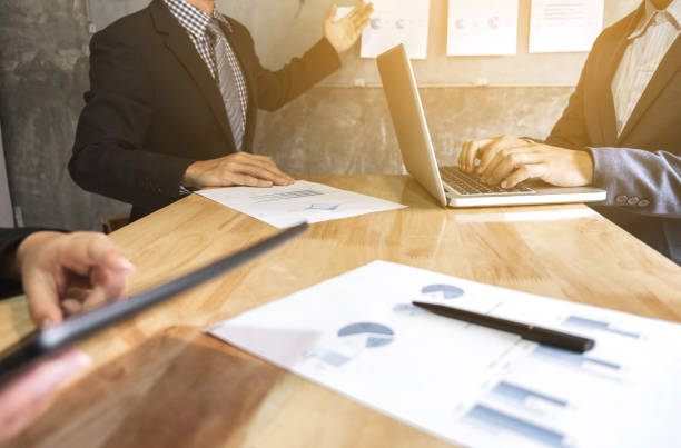 istock Business executive pointing graph presentation to colleagues in office, during meeting, explaining, consultation 840582292