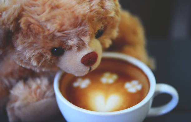 istock Teddy bear and coffee cup on table in the cafe. 840586810