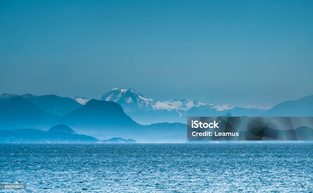 View of the Coast Mountains of continental British Columbia from Vancouver Island, north of Nanaimo. Canada View of the Coast Mountains of continental British Columbia (the Canadian portion of the Cascade Mountains/Pacific Cordillera) across the Georgia Strait from Vancouver Island, north of Nanaimo. Canada Sea Stock Photo