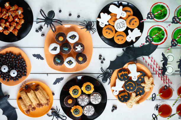 Halloween candy bar High angle view of various decorated treats for Halloween celebration halloween cupcake stock pictures, royalty-free photos & images