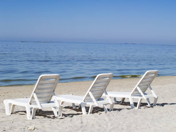 istock Three sun loungers on a deserted beach 840598864