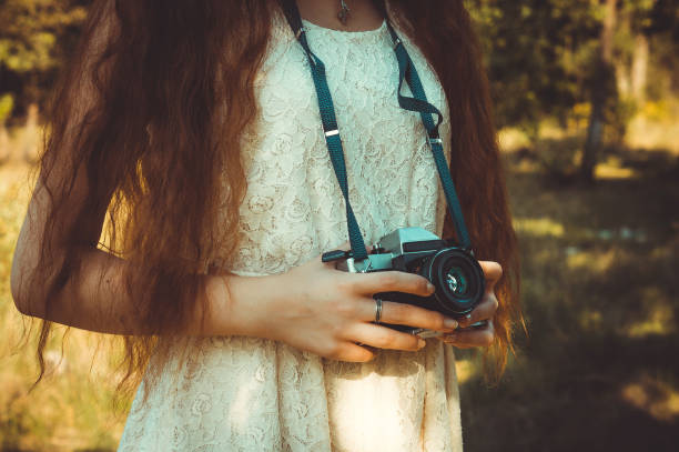 istock Elegance girl photographer holding retro camera 840599670