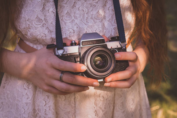 istock Elegance girl photographer holding retro camera 840599698