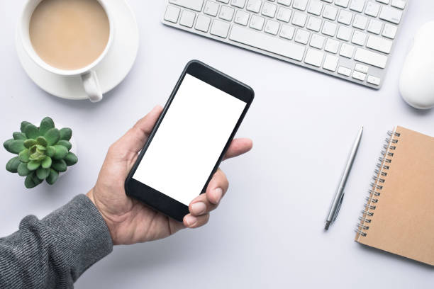 istock Male hand holding smartphone on office desk table.copy space 840599868