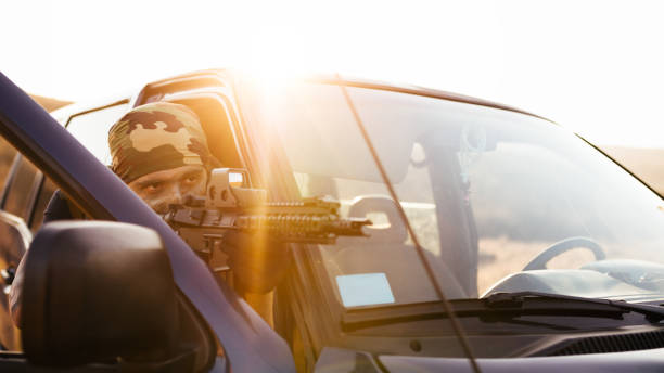 istock Soldier covered behing car door 840602590