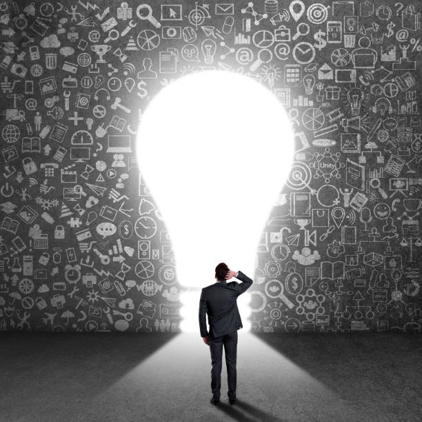 istock Confused businessman looking at light bulb 840610056
