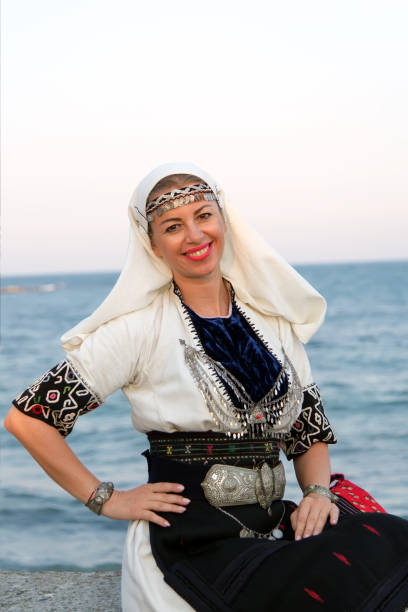 istock Woman in authentic folklore clothes in old Nessebar. Soft focus. 840610256