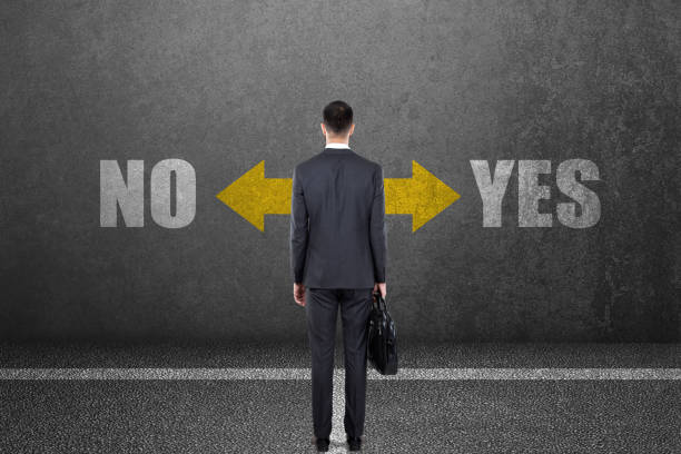 Businessman with yes or no choice on wall