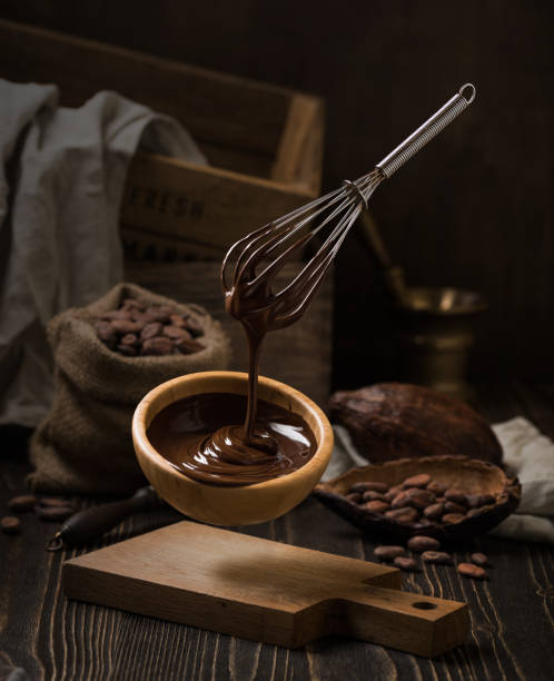 istock Dark still life with melted chocolate in wooden bowl 840611390