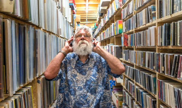 istock Record collector with headset on, in front of his collection 840611574