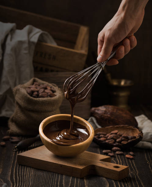 istock Dark still life with melted chocolate in wooden bowl 840611586