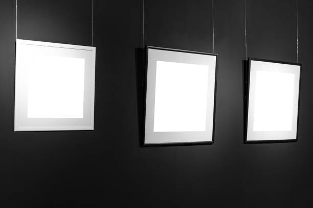 istock Three empty frames on black wall. Blank space posters or art frame waiting to be filled. Square Black and White Frames Mock-Up 840611784