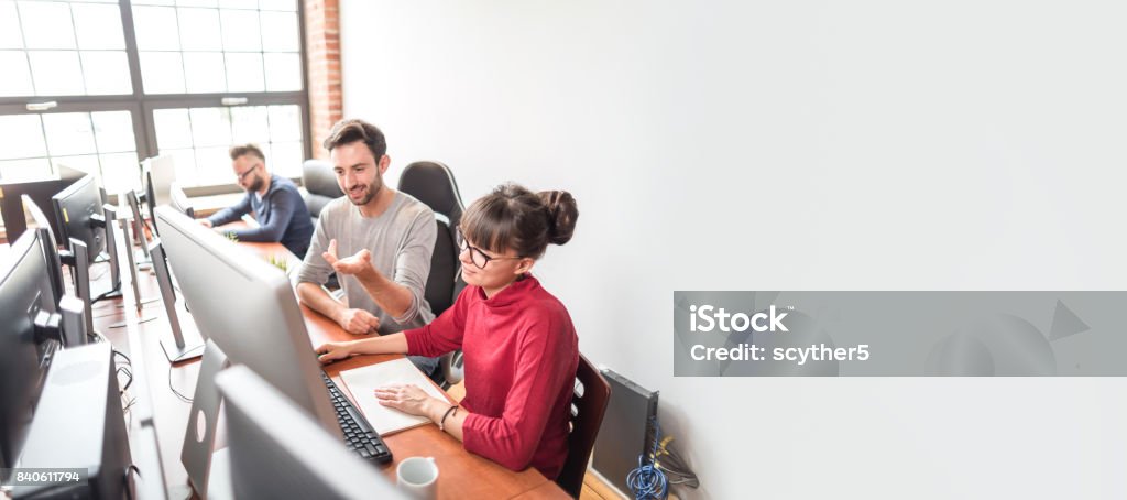 Website design. Developing programming and coding technologies. Developing programming and coding technologies. Website design. Programmer working in a software develop company office. Teamwork Stock Photo