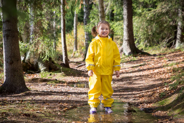 istock Cute little girl jumping in muddy puddle 840614640